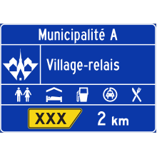 Village-relais sign (exit advance guide sign — 2 km)